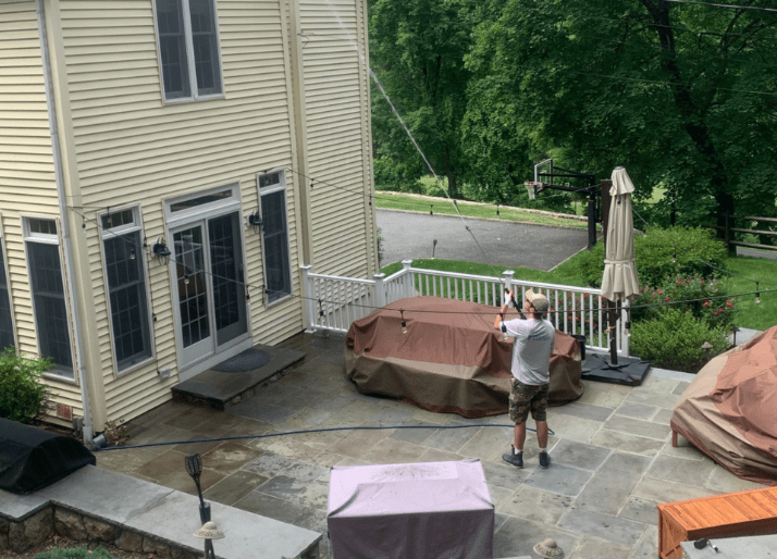 Team member washing a house in Armonk, NY.